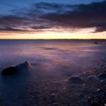 Sunset above the pebble beach of Mølen